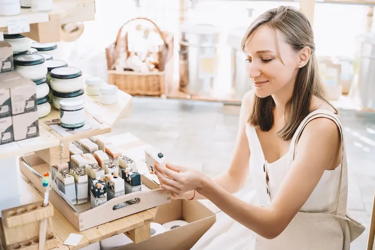 Vendedora avaliando itens de cosméticos antes de cadastrar os produtos no sistema